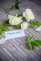 beautiful white summer roses, on a wooden table photo