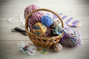 Colored threads, knitting needles and other items for hand knitting photo