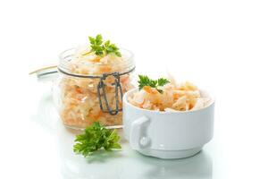 Sauerkraut with carrots and spices in a glass jar photo