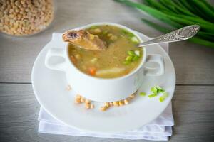 dried pea soup in a plate with herbs photo