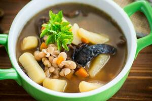 mushroom hot soup with beans in a bowl photo