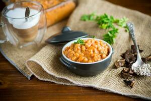 beans stewed with vegetables and spices, in a bowl . photo