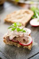 sandwich with baked meat, radish and herbs photo