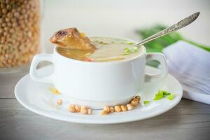 dried pea soup in a plate with herbs photo