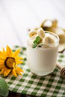 Sweet homemade yogurt with bananas and honey photo