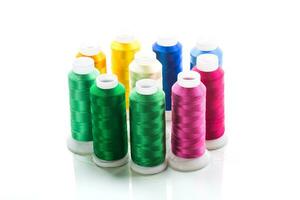 set of different color sewing threads,on white background. photo