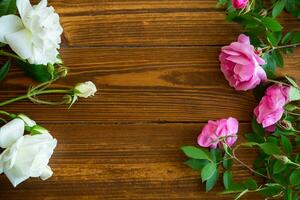 Floral background of pink and white roses on a dark wooden photo