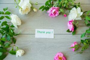 Floral background of pink and white roses on a light wooden photo