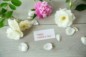 bouquet of summer white roses and peonies on wooden table photo