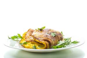 Fried omelette with zucchini,in a plate on a white background. photo