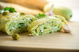 vegetable zucchini roll with garlic cheese filling inside. photo