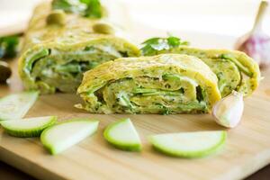 vegetable zucchini roll with garlic cheese filling inside. photo