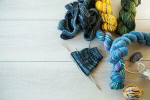 Colored threads, knitting needles and other items for hand knitting photo