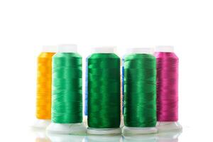 set of different color sewing threads,on white background. photo