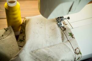 Sewing machine with fabric and threads for sewing, close-up. The working process photo