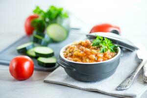 Cooked white beans with zucchini and other vegetables. photo