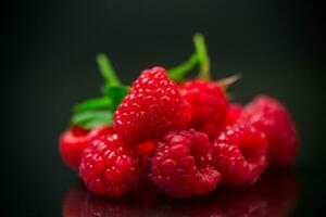 Sweet raspberry fruit isolated on black background photo