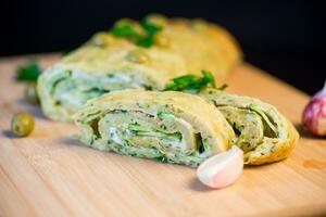 vegetable zucchini roll with garlic cheese filling inside. photo