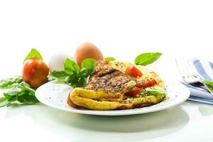Stuffed omelette with tomatoes isolated on white background. photo