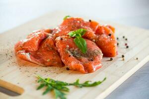 Fresh big pieces of salted red fish with spices and herbs . photo