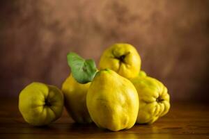 Ripe natural autumn quince on wooden table. photo