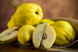 Ripe natural autumn quince on wooden table. photo