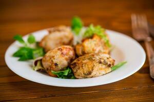 Fried pieces of chicken fillet breaded with spices and herbs in a plate . photo