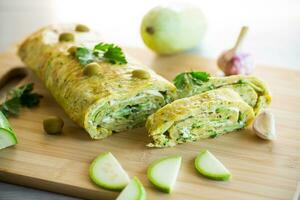 vegetable zucchini roll with garlic cheese filling inside. photo