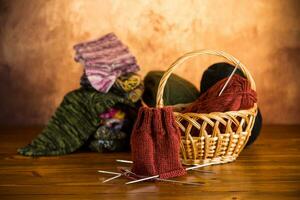 Colored yarn, knitting needles and other items for hand knitting . photo