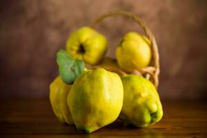 Ripe natural autumn quince on wooden table. photo