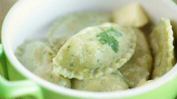 gekocht Knödel mit Füllung innen, von Teig mit Kräuter im ein Keramik Platte. video