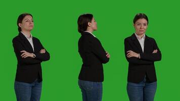 Close up of stylish woman wearing office suit in studio, acting positive and confident over green screen backdrop. Corporate worker being formal, company employee smiling on camera. photo