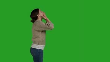 Profile of lovely person blowing kisses on camera to show love, expressing romantic feelings and optimistic emotions. Young adult acting confident and cheerful, being friendly on studio backdrop. photo