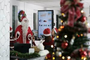 Seasoner lecturer pitching insights on leadership required skills in business meeting with employees during Christmas holiday season. Workers discussing over statistics in festive ornate workspace photo