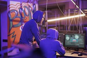 Hackers getting access denied on server while using malware on computer. Unhappy criminals in hoods breaking network system unsuccessfully while doing illegal crime activites photo