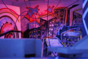 Rusty structure of warehouse with bright neon lights in state of ruins, looking creepy. Abandoned building showing signs of disintegration, glowing in dark with fluorescent purple light. photo