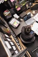 Top view of police officer discussing with remote inspector during online videocall meeting conference on laptop computer. Private detectives working overtime at criminal case in arhive room photo