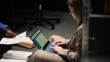Focus on female private detective diligently using laptop in incident room, examining evidence and reviewing statements to solve complex case. Police officer thrilled for getting crucial information. photo
