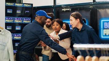 Retail store opening on black friday, letting customers inside shopping center during seasonal sales. Diverse people anxious to start shopping at half price, ready to find best deals. photo