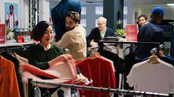 Shoppers looking for best deals, buying merchandise on black friday from shopping center. Diverse crowd of customers searching for high sale red price tag, bargain hunting concept. photo