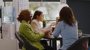 Diverse team of coworkers doing collaboration in office to plan annual report, checking online analytics on files in coworking space. Female workers discussing corporate growth. Tripod shot. photo
