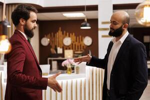 Professionals shake hands at meeting, creating new future partnership between corporations. Businessmen successfully collaborating on project at conference, handshake agreement. photo