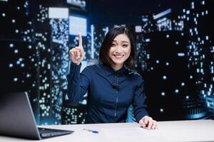 Talk show host covering latest news and events, creating daily reportage for the viewers. Asian presenter working as media newscaster discussing current topics on international tv program. photo