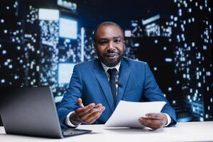 Newscaster hosting talk show live on television program, debating essential daily events and incidents. African american tv reporter broadcasting news reportage on entertainment segment. photo