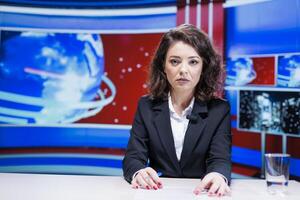 Anchorwoman reporting live information regarding daily events, hosting media segment on global television broadcast. Newscaster presenting reportage with latest breaking news. photo