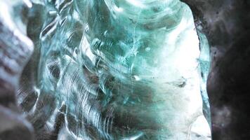 Ice crevasse with glacier rocks at vatnajokull mass, inside ice caves with transparent crashed icebergs. Spectacular blue icy blocks in arctic icelandic scenery, glacier hiking. Handheld shot. photo