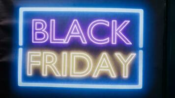 Glowing black friday sale signs on entrance front door at mall, local clothing store offering promotions and big discounts during seasonal sale. Clothes shop marketing advertisement. photo