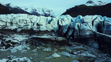 Aerial view of blue glacier rocks on vatnajokull ice cap in iceland, diamond shaped icelandic icy blocks. Spectacular icebergs and crevasses forming amazing nordic landscape. Slow motion. photo