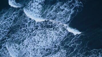 Aerial view of arctic ocean shore with black sand beaches, nordic skyline landscape. Beautiful atlantic coastline scenery in iceland with snowy mountains and icelandic weather. Slow motion. photo