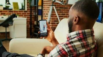 Patient lying on couch remotely discussing treatment plan with doctor during online video call meeting after medical checkup. Man receiving prescription from general practitioner in telemedicine call photo